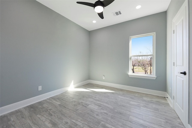 spare room featuring light hardwood / wood-style floors and ceiling fan