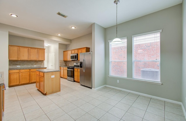 kitchen featuring pendant lighting, decorative backsplash, light tile patterned floors, a kitchen island, and stainless steel appliances