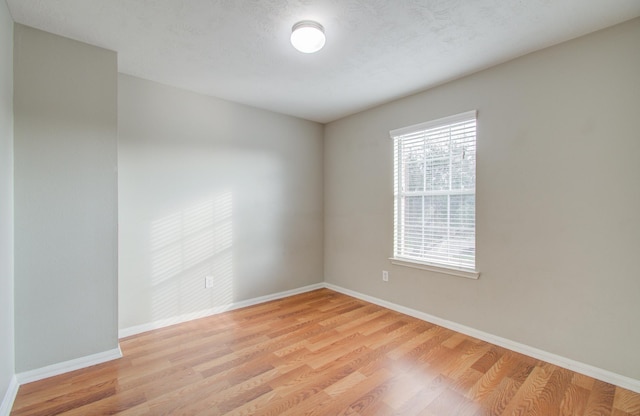 unfurnished room with light wood-type flooring