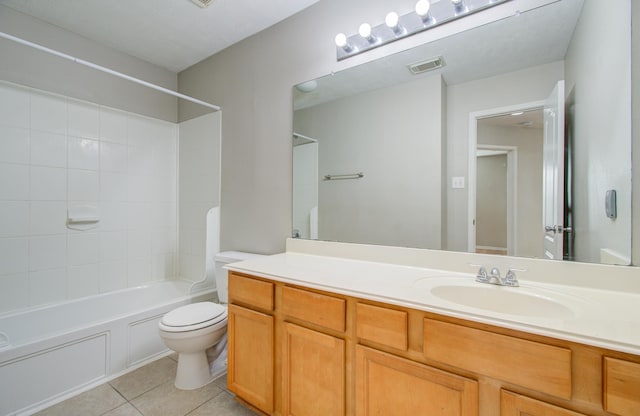 full bathroom featuring tile patterned floors, vanity, tiled shower / bath combo, and toilet