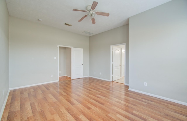 unfurnished room with light wood-type flooring and ceiling fan