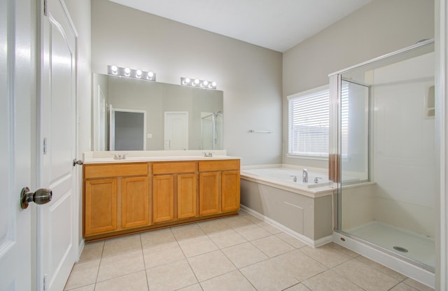 bathroom featuring tile patterned flooring, shower with separate bathtub, and vanity