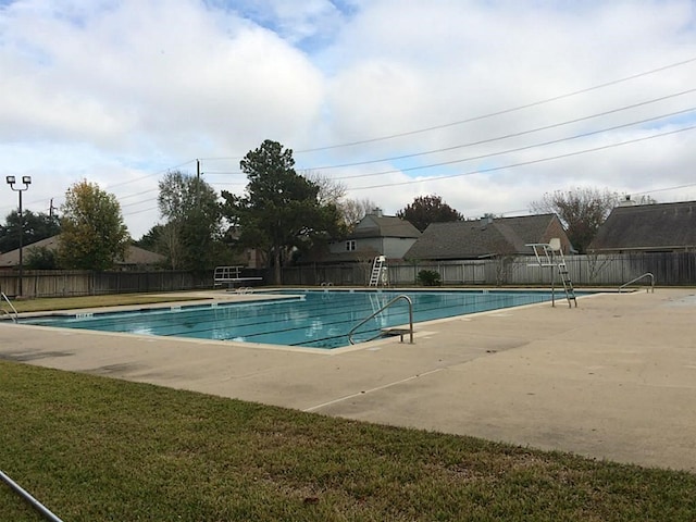 view of pool featuring a yard and a patio