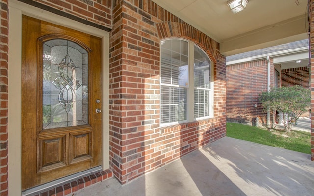 view of exterior entry with a porch