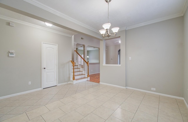 empty room with light tile patterned floors, an inviting chandelier, and ornamental molding