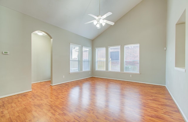 empty room featuring ceiling fan, light hardwood / wood-style flooring, and high vaulted ceiling