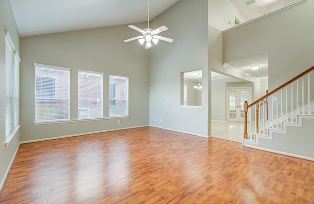 unfurnished living room featuring light hardwood / wood-style floors and high vaulted ceiling