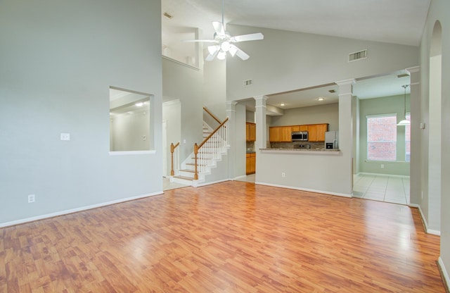 unfurnished living room featuring ceiling fan, light hardwood / wood-style floors, and high vaulted ceiling