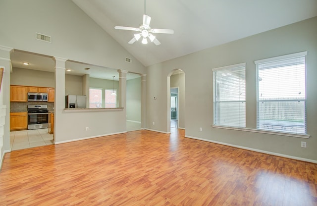 unfurnished living room with light wood-type flooring, high vaulted ceiling, and ceiling fan