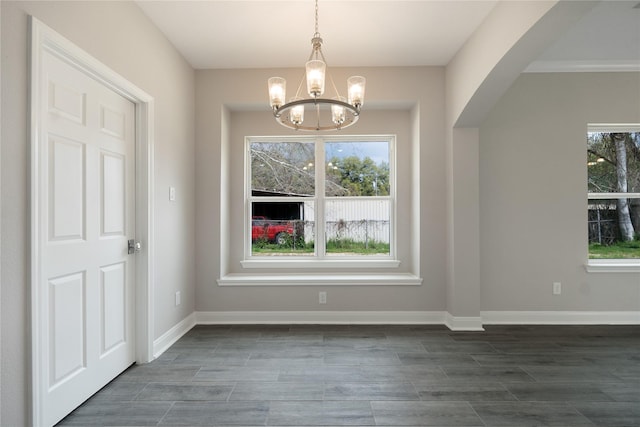 unfurnished dining area featuring a chandelier