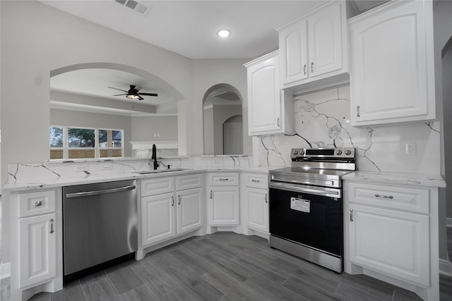 kitchen with white cabinetry, sink, ceiling fan, tasteful backsplash, and appliances with stainless steel finishes