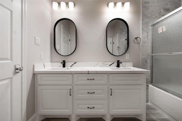 bathroom featuring vanity and enclosed tub / shower combo