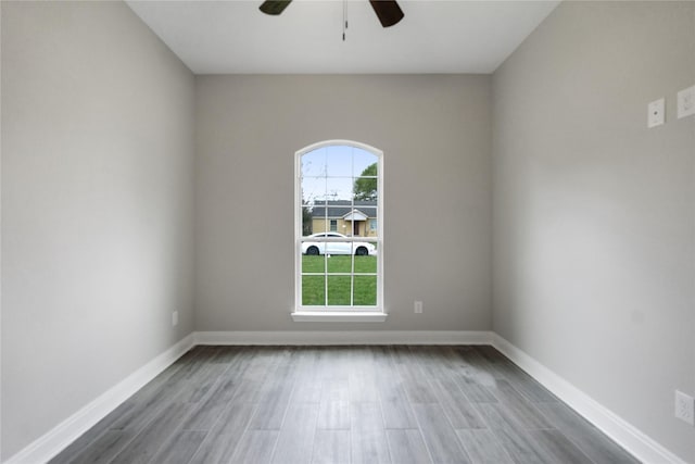 empty room with ceiling fan and wood-type flooring