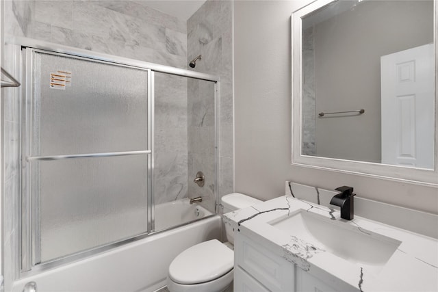 full bathroom with shower / bath combination with glass door, vanity, and toilet