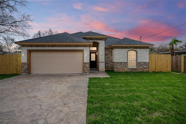 view of front of house with a garage and a lawn