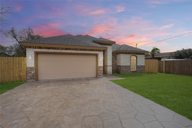 view of front of property with a lawn and a garage