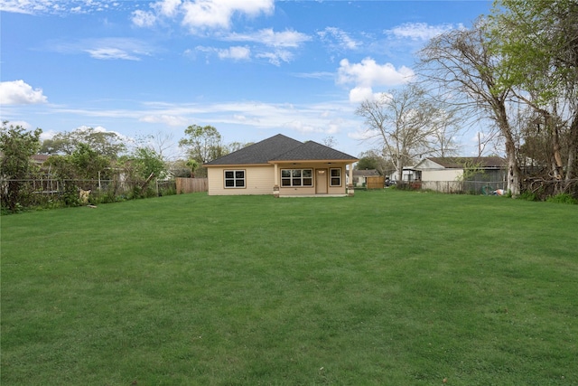 back of house with a yard and a patio area