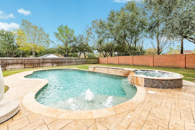 view of pool featuring an in ground hot tub, pool water feature, and a patio