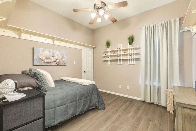 bedroom featuring hardwood / wood-style floors and ceiling fan