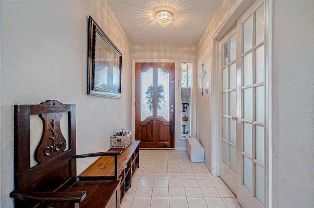 foyer entrance with light tile patterned flooring