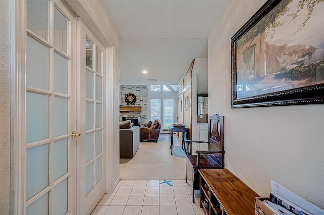 hallway with light colored carpet