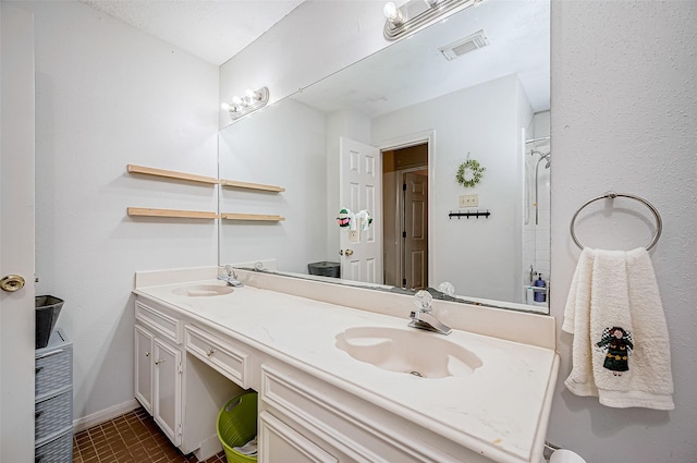 bathroom with tile patterned floors and vanity