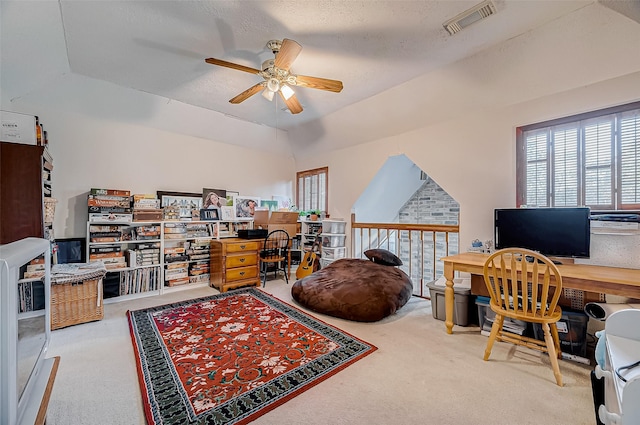 home office with carpet, ceiling fan, lofted ceiling, and a textured ceiling