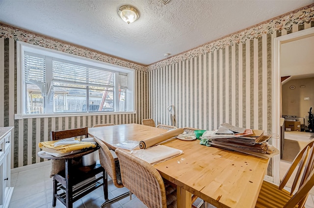 tiled dining area featuring a textured ceiling