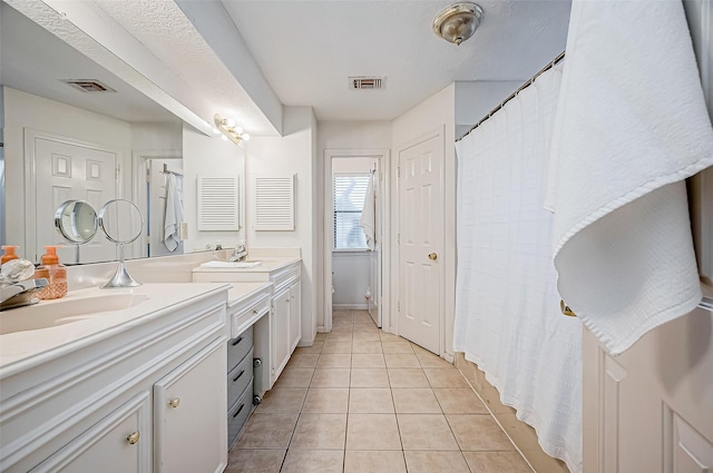 bathroom with tile patterned floors, vanity, and toilet