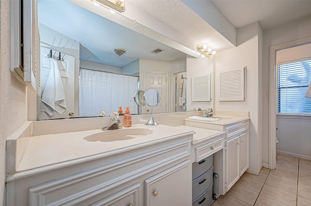 bathroom featuring tile patterned flooring and vanity