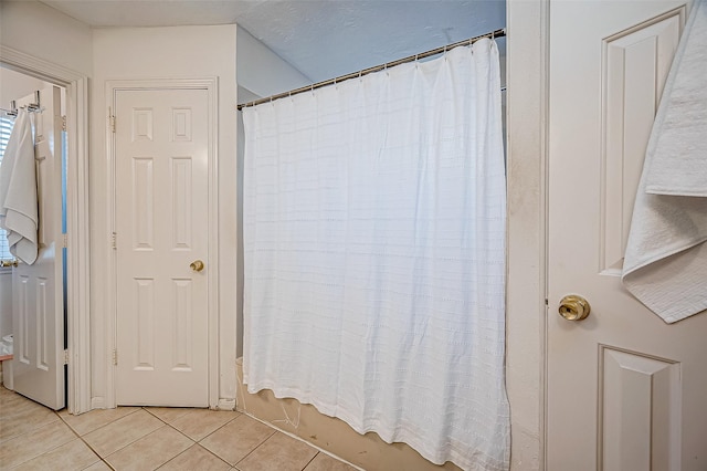 bathroom with tile patterned floors and shower / tub combo