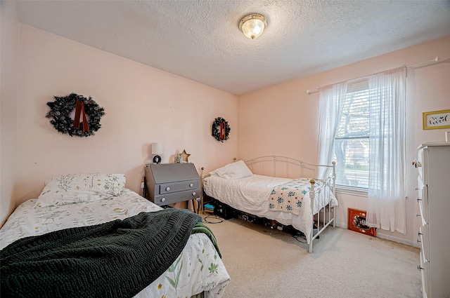 bedroom featuring a textured ceiling and light carpet