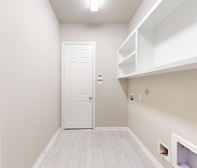 laundry area with washer hookup and light hardwood / wood-style floors