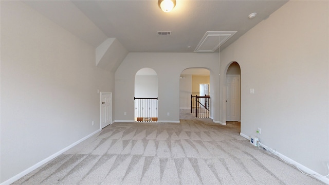 carpeted empty room with a towering ceiling