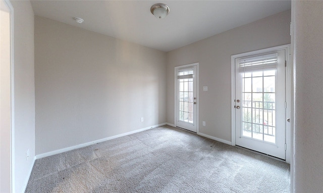 unfurnished room featuring light colored carpet