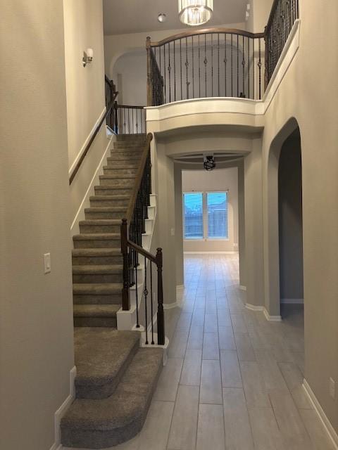 entrance foyer featuring hardwood / wood-style flooring and a towering ceiling