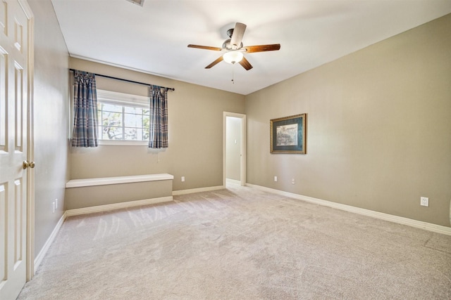 empty room with light carpet and ceiling fan