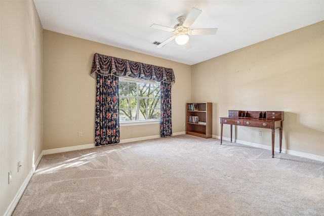 unfurnished room with ceiling fan and light carpet