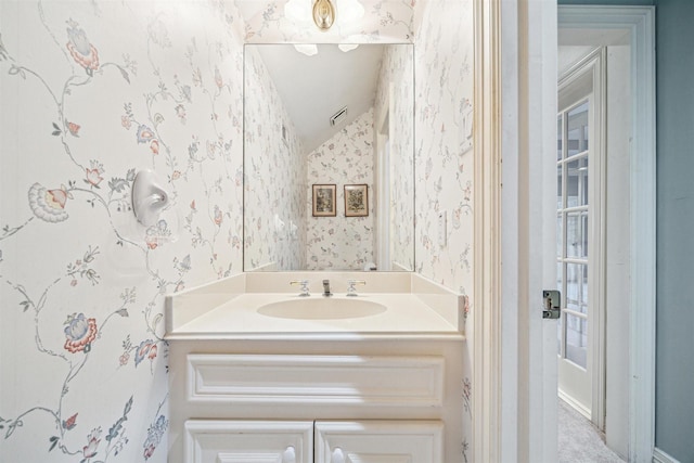 bathroom with sink and vaulted ceiling