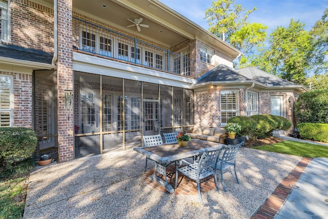 exterior space featuring a balcony, ceiling fan, and a sunroom