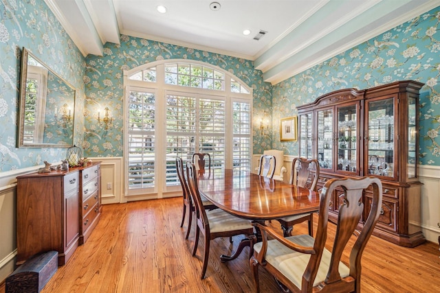 dining space with light hardwood / wood-style flooring and ornamental molding