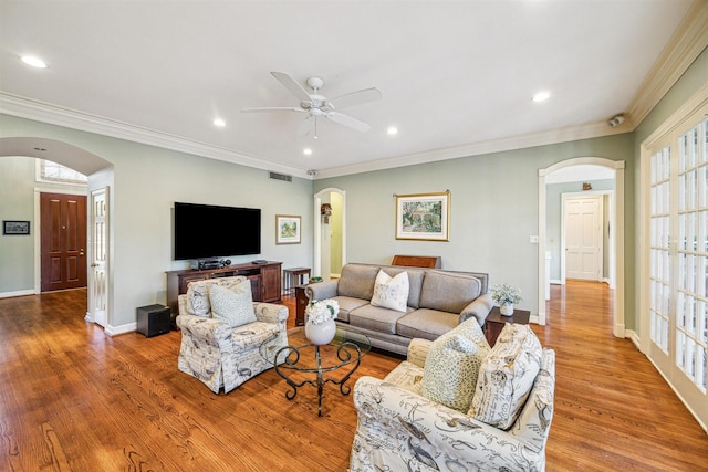 living room with ceiling fan, light hardwood / wood-style floors, and ornamental molding