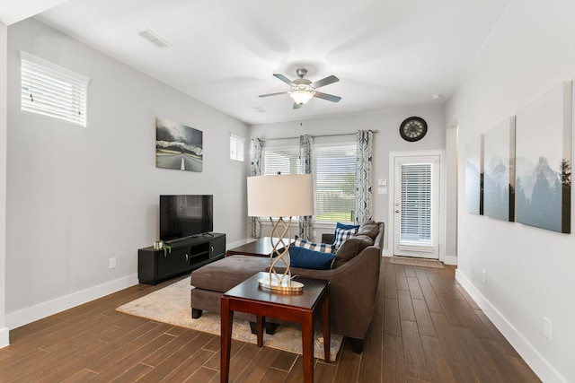 living room featuring ceiling fan and dark wood-type flooring