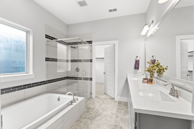 bathroom featuring separate shower and tub and vanity