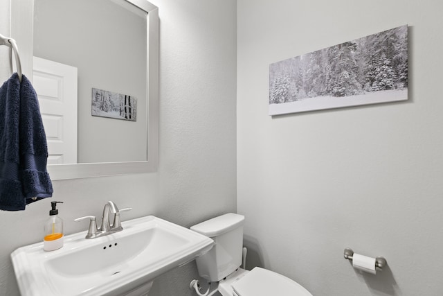 bathroom with sink and toilet