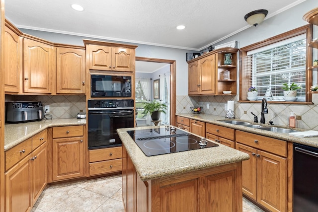 kitchen with sink, crown molding, decorative backsplash, a kitchen island, and black appliances