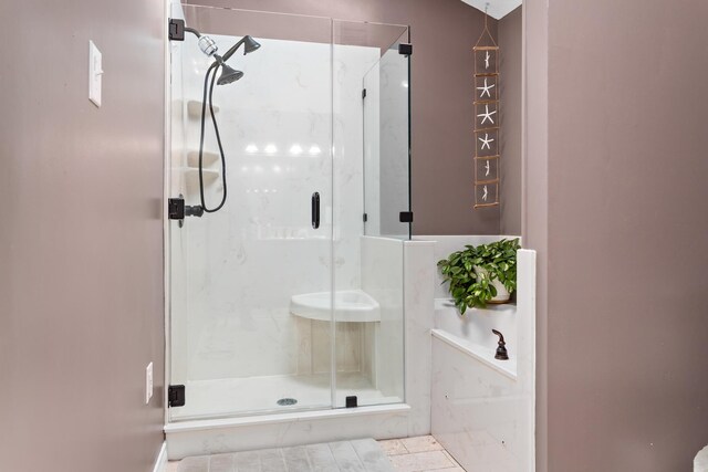 bathroom featuring tile patterned floors and an enclosed shower