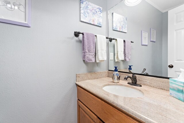 bathroom featuring vanity and crown molding