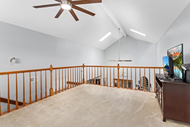 interior space featuring carpet and vaulted ceiling with skylight