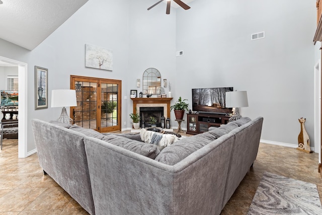 living room with ceiling fan and high vaulted ceiling